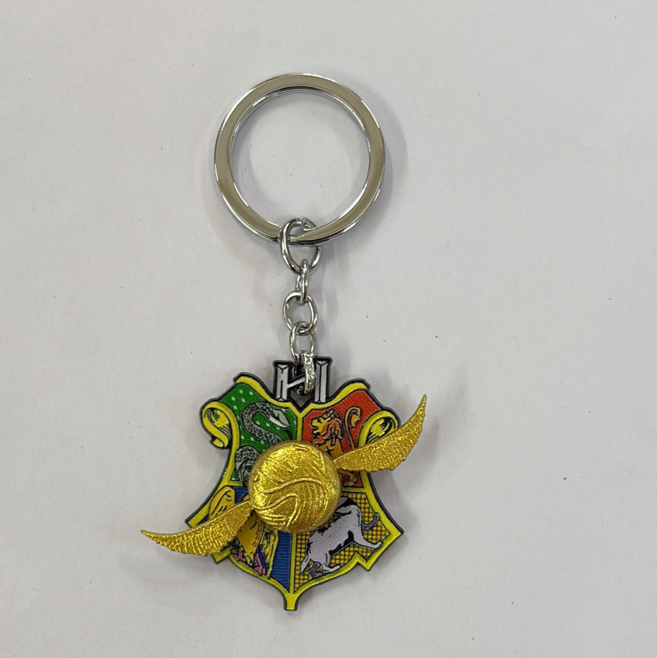 Harry Potter Quidditch Snitch On Hogwarts House Crest Rotating Keychain with Bagcharm